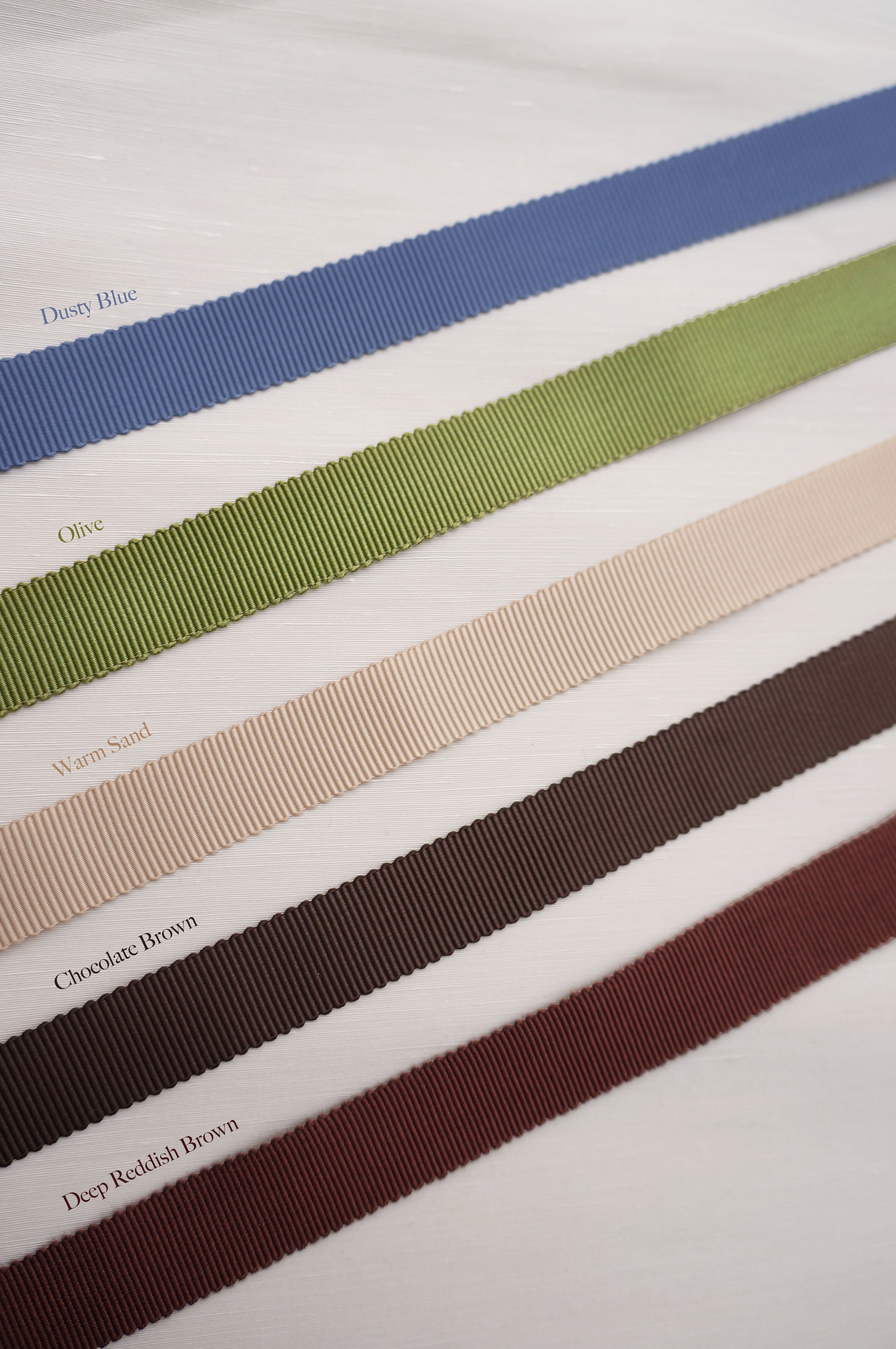 High-quality grosgrain trim options for Winther Wackerhausen shower curtains, shown in Dusty Blue, Olive, Warm Sand, Chocolate Brown, and Deep Reddish Brown