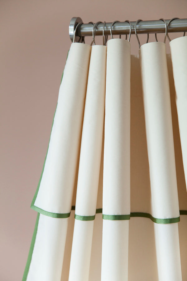 Close-up of the Winther Wackerhausen Contour shower curtain featuring layered fabric folds and a refined green trim detail