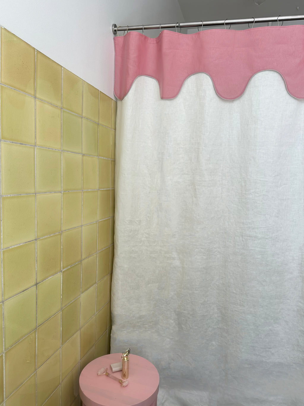 Winther Wackerhausen Drizzle shower curtain featuring a soft pink scalloped top layer and linen-textured main panel, shown in a styled bathroom with yellow tiles