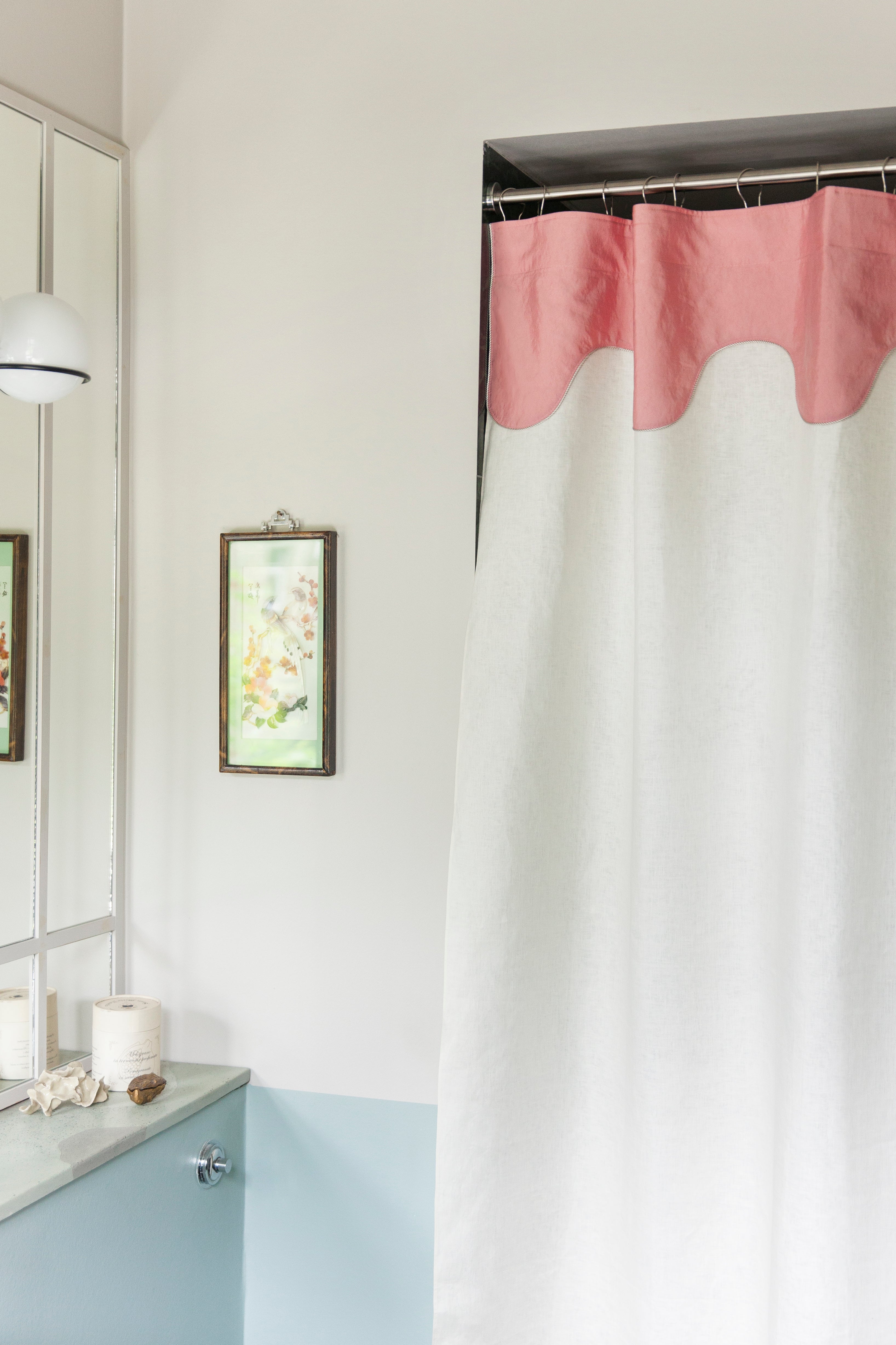 Winther Wackerhausen Drizzle shower curtain featuring a pink scalloped top panel and white linen-textured body, shown in a light, pastel-toned bathroom interior